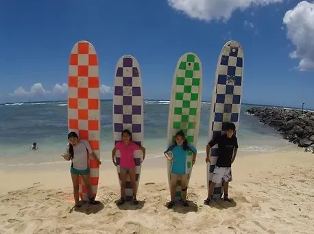 Group of people at a surf lesson on a Hawaiian beach