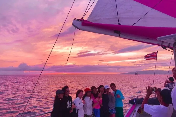 Group of people on a sailing boat watching the sunset in Waikiki