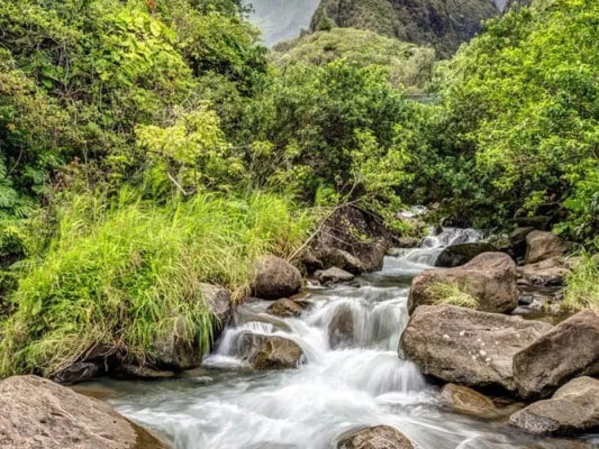 A large waterfall over a rocky cliff in Maui